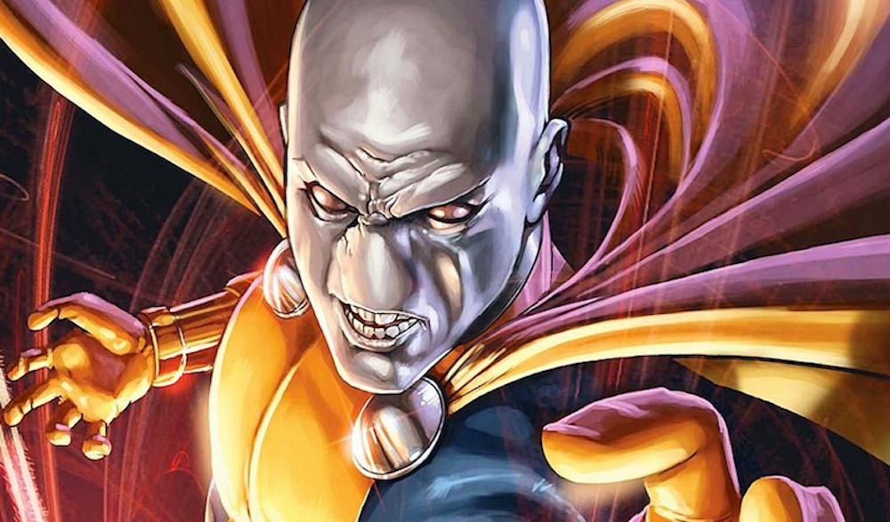 An image of Morph from the comics with a cape and their gray/white nondescript-face look.