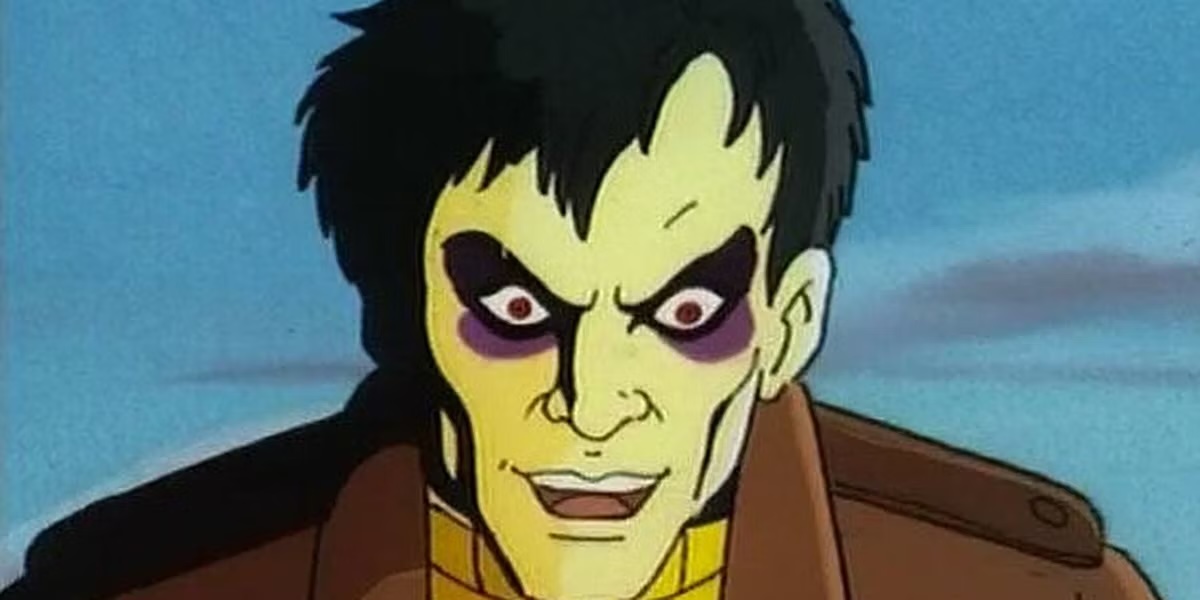 An image of Morph from the X-Men animated series while they're under the influence of Sinister; they have dark circles around their eyes and an evil grin.